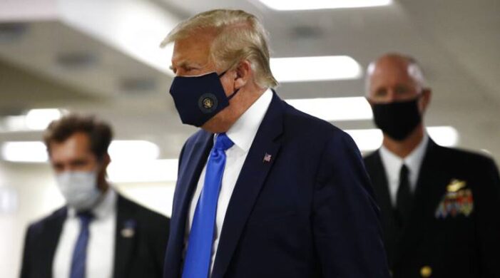 In first, Trump dons masks in visit to a military medical facility