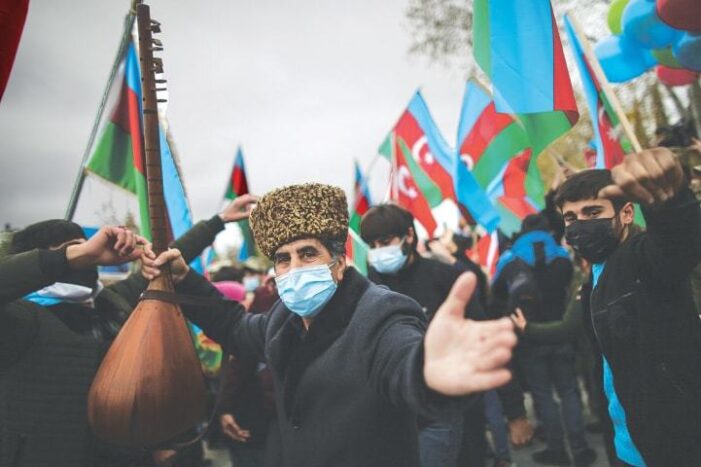 Azerbaijani troops hoist flag in district given up by Armenia under peace deal